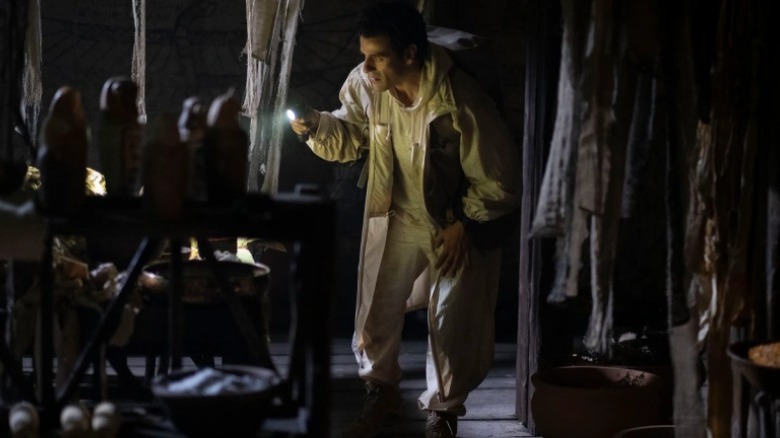 Steven shines flashlight on relics