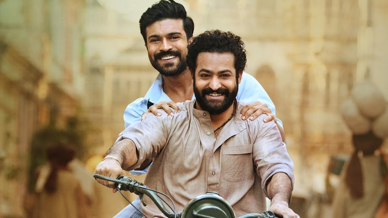 N. T. Rama Rao Jr. and Ram Charan as Bheem and Raju riding a motorcycle together in RRR