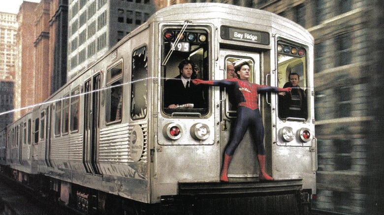 Tobey Macguire as Spider-Man trying to stop a train in Spider-Man 2 (2004)