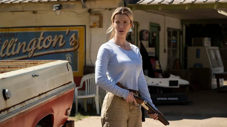 Betty Gilpin as Crystal May Creasey, holding a shotgun in The Hunt.
