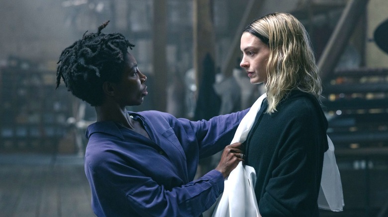 Michaela Coel's Sam holds up fabric on Anne Hathaway's Mother Mary in Mother Mary