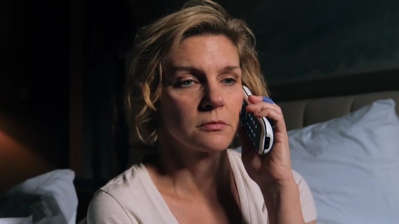 Rhea Seehorn's Carol Sturka holding a phone on Pluribus