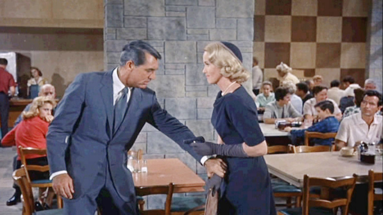 Roger Thornhill (Cary Grant) grabs Eve Kendall (Eva Marie Saint) as she holds a gun on him in North by Northwest