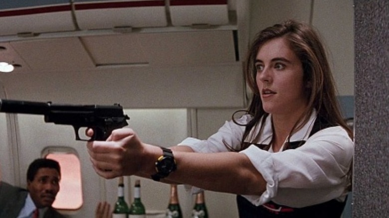 Sabrina Ritchie (Elizabeth Hurley) aims a gun in Passenger 57