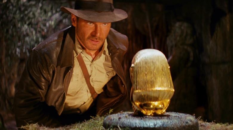 Harrison Ford's Indiana Jones approaches the Golden Idol in Raiders of the Lost Ark