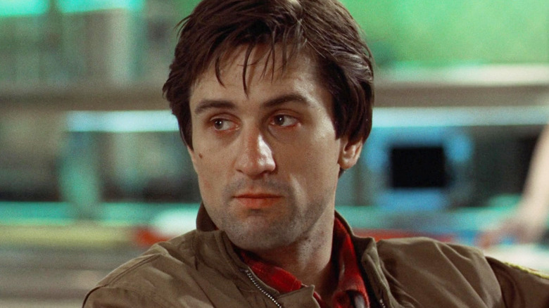 Robert De Niro as Travis Bickle sitting in a restaurant in Taxi Driver