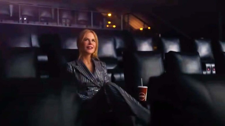 nicole kidman sitting in a movie theatre with a soda cup