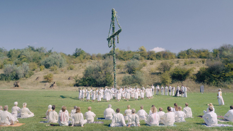 Cultists dance around a maypole