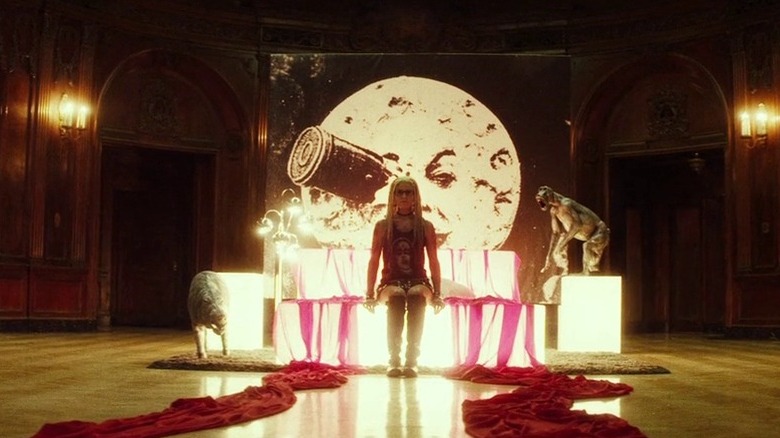 Sheri Moon sits in front of  Man in the Moon