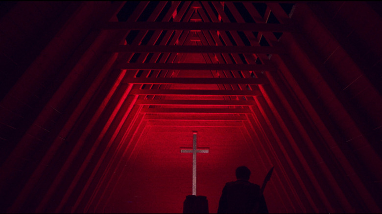 Nic Cage in front of giant cross