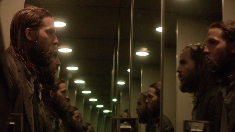 Logan Marshall-Green looks at himself in a mirror