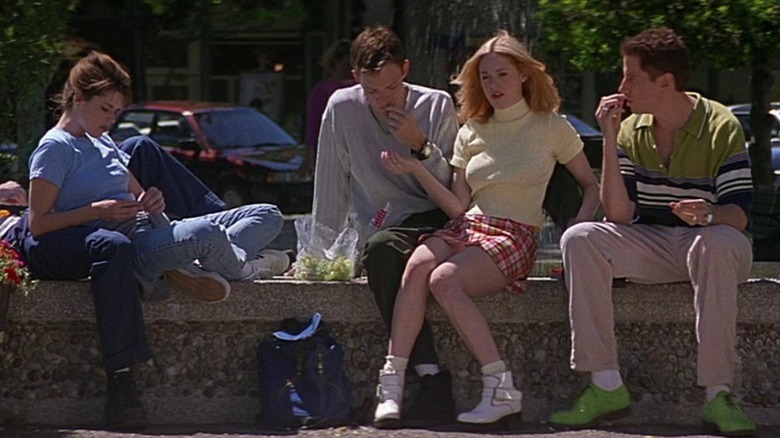 Cast of Scream sitting on school fountain.