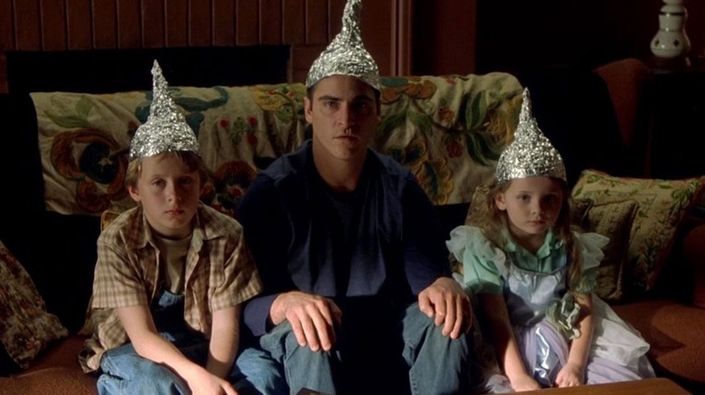 Joaquin Phoenix with kids in tin foil hats