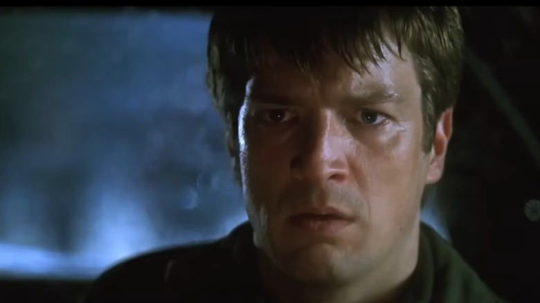 Nathan Fillion in a car at night