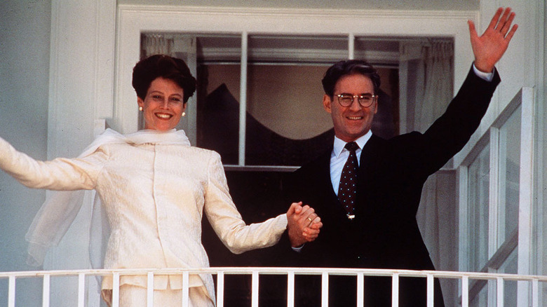 Sigourney Weaver holding hands with Kevin Kline