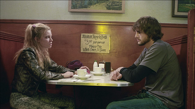 Evan and Kayleigh sitting in a booth