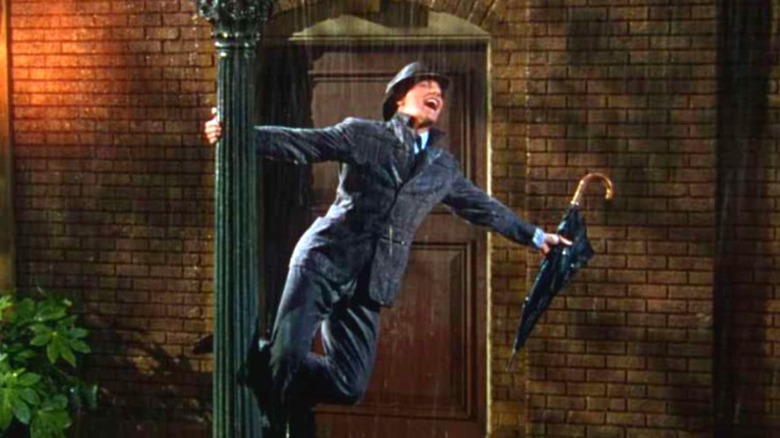 Don Lockwood swinging on a lamp post