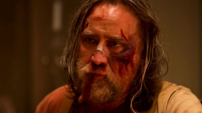 Nicolas Cage in Pig bloody bandage on nose
