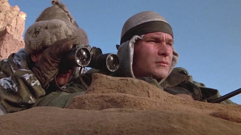 Swayze watches the enemy movements.