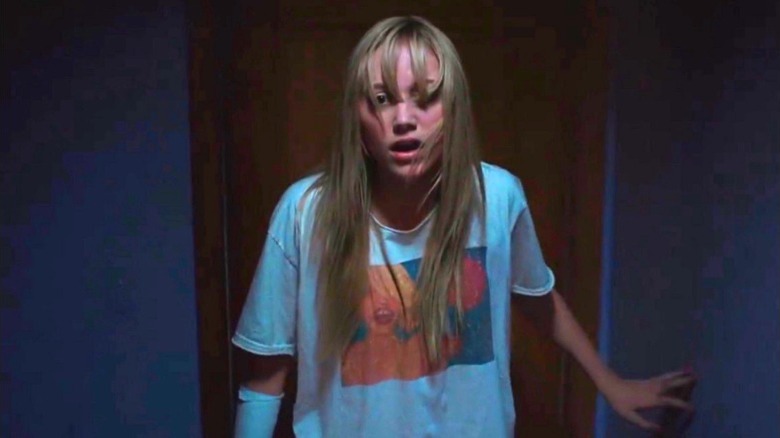Maika Monroe walking slowly