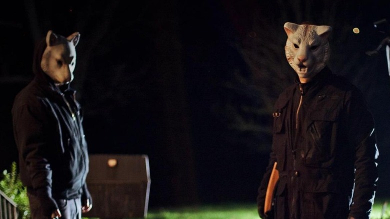 Masked men outside house