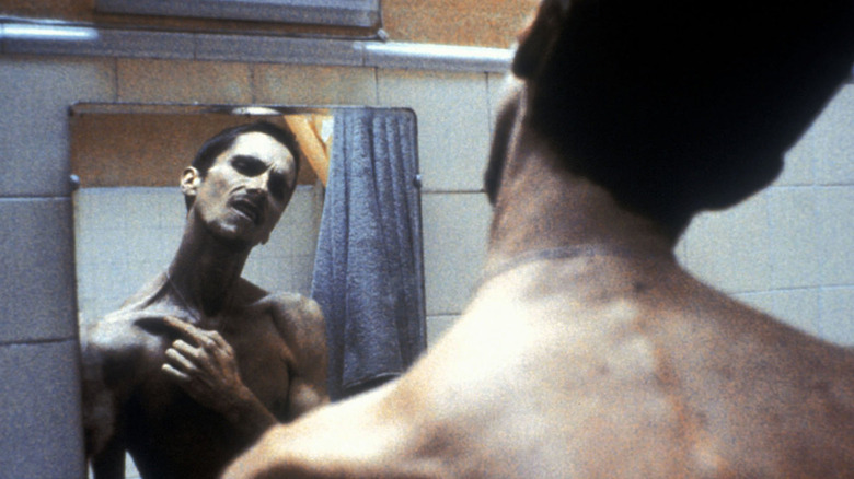 Christian Bale looks at himself in mirror
