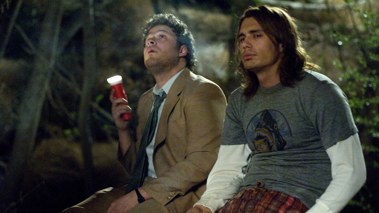 Seth Rogen and James Franco sitting outdoors