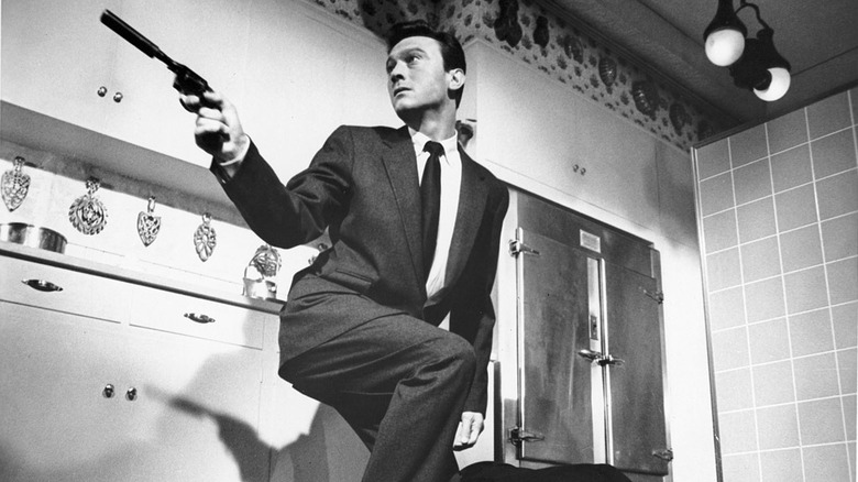 Manchurian Candidate wields a gun
