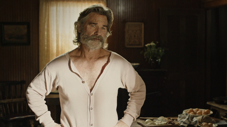 Kurt Russell as Sheriff Franklin Hunt in Bone Tomahawk, in his sleeping clothes looking off at someone.