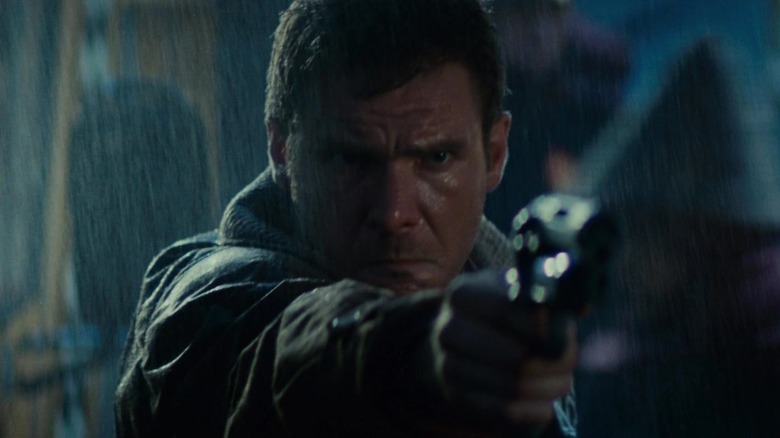 Harrison Ford as Rick Deckard aims gun
