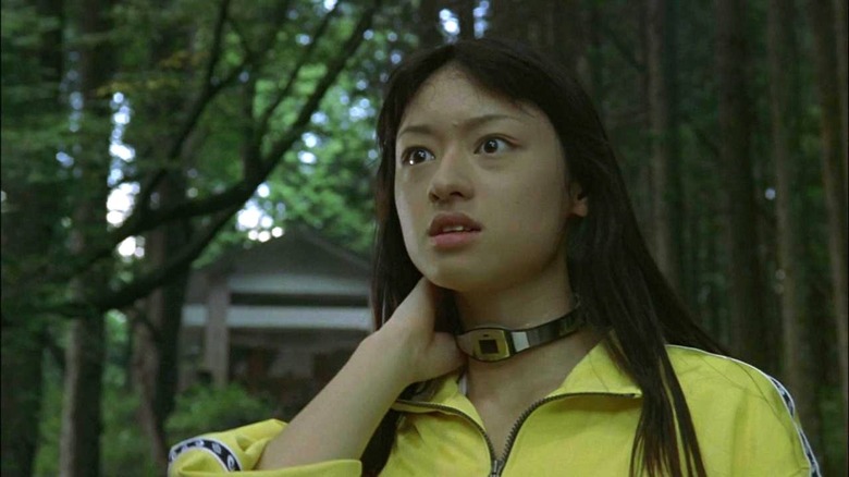 Chigusa holds necklace