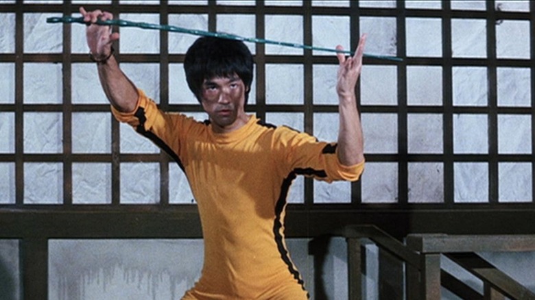 Billy Lo holds a long weapon