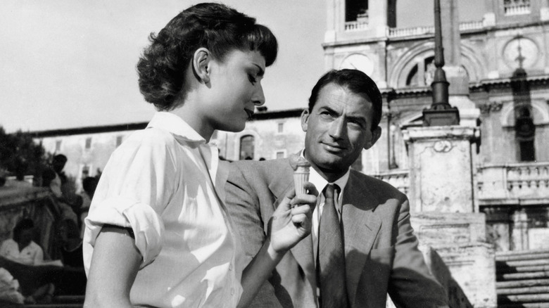 Ann and Joe converse in the midst of Rome