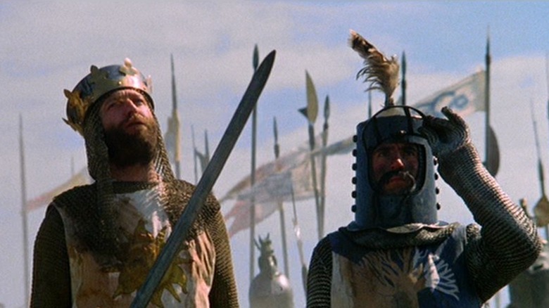 King Arthur lifts his sword