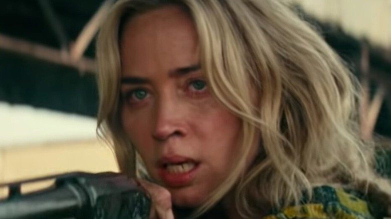 Emily Blunt aims a gun