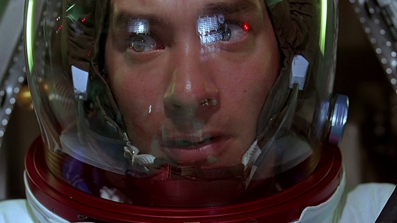 Tom Hanks as Jim Lovell looking scared in his astronaut gear in Apollo 13