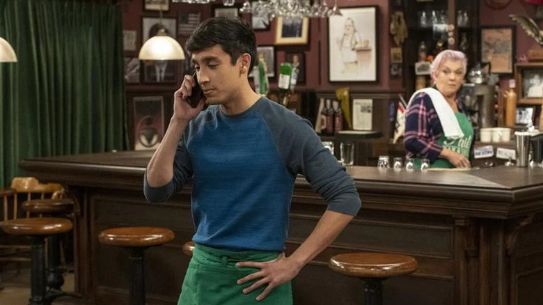 Adan Rocha as Miguel Gonzales, standing in front of Phyllis (Tyne Daly) at the bar in Murphy Brown