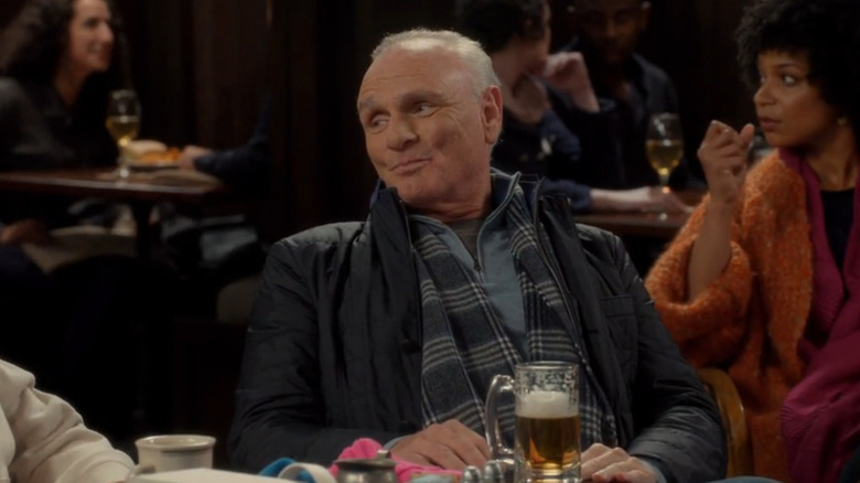 Joe Regalbuto as Frank Fontana smiling at the bar in Murphy Brown
