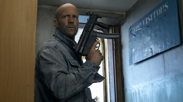 Cole Reed holding a gun in a ship hallway in Mutiny