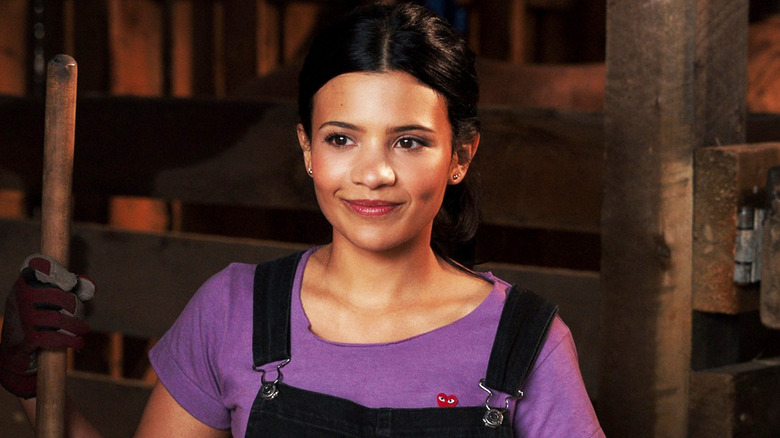 Nikki Rodriguez's Jackie Howard smiles as she stands in a barn in My Life with the Walter Boys