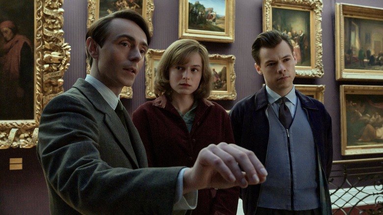 david dawson, emma corrin, and harry styles looking at art in the movie my policeman