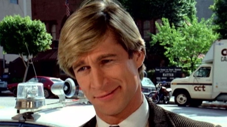 Simon MacCorkindale has a floppy head of hair as Jonathan Chase in Manimal