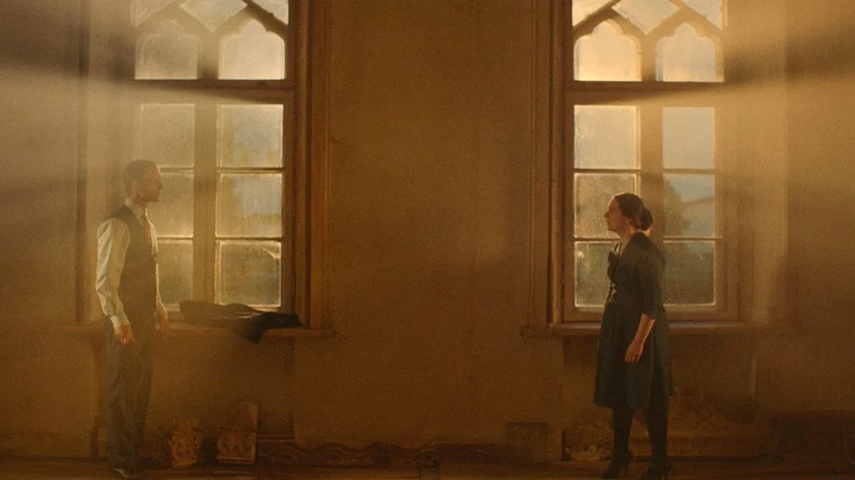 Dark hallway with two people