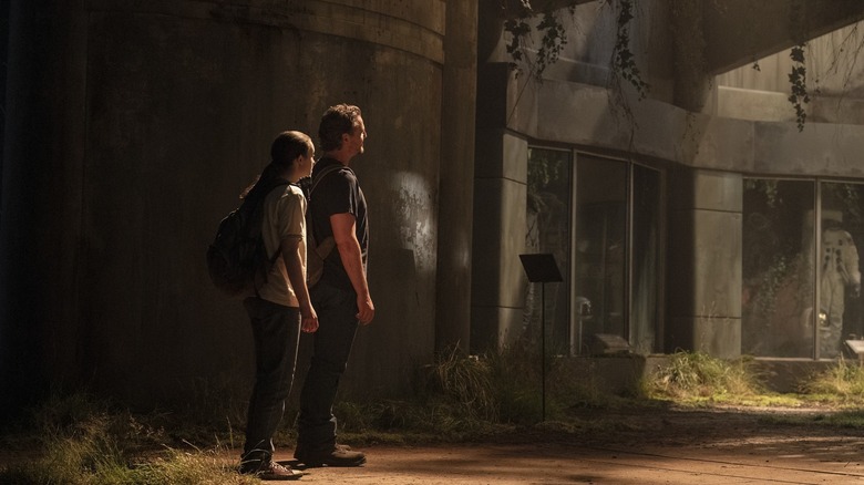 Ellie and Joel looking at something in The Last of Us