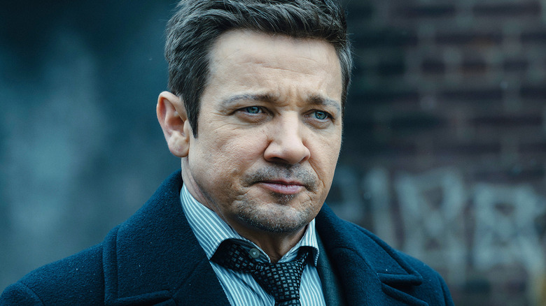 Jeremy Renner's Mike McLusky is seen in closeup as he stands outside in Mayor of Kingstown