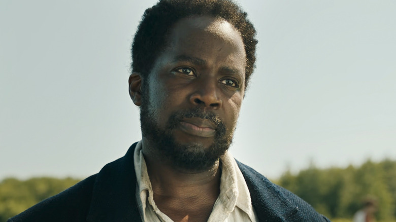 Harold Perrineau's Boyd Stevens stands in a field looking off into the distance in From