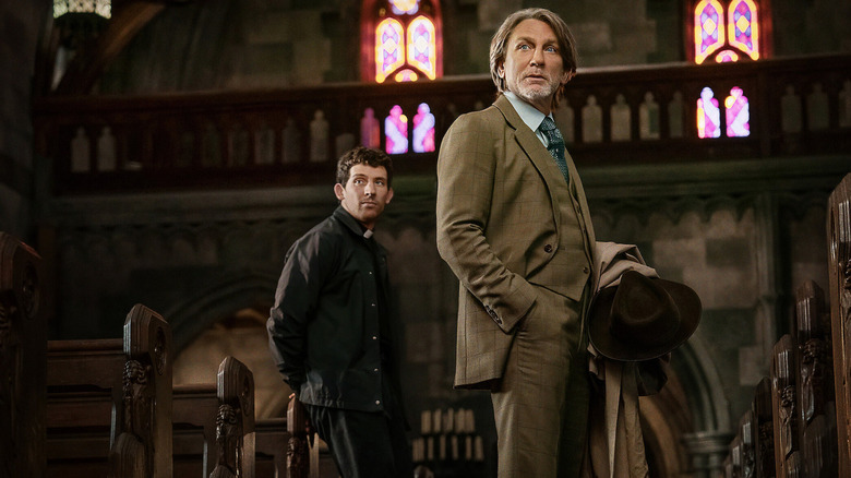 Benoit Blanc looks up inside a church in Wake Up Dead Man: A Knives Out Mystery