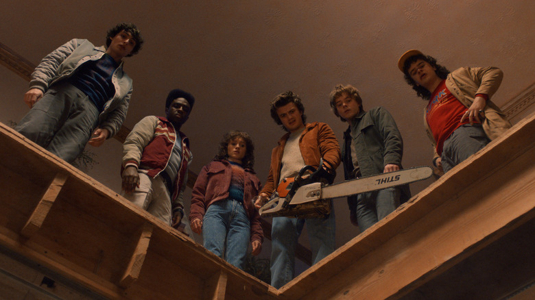 Lucas, Dustin, Steve, Nancy, Jonathan, and Mike staring down into a hole from above in Stranger Things season 5