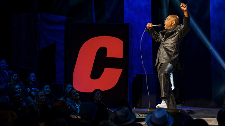 Dave Chappelle raising a fist in The Closer