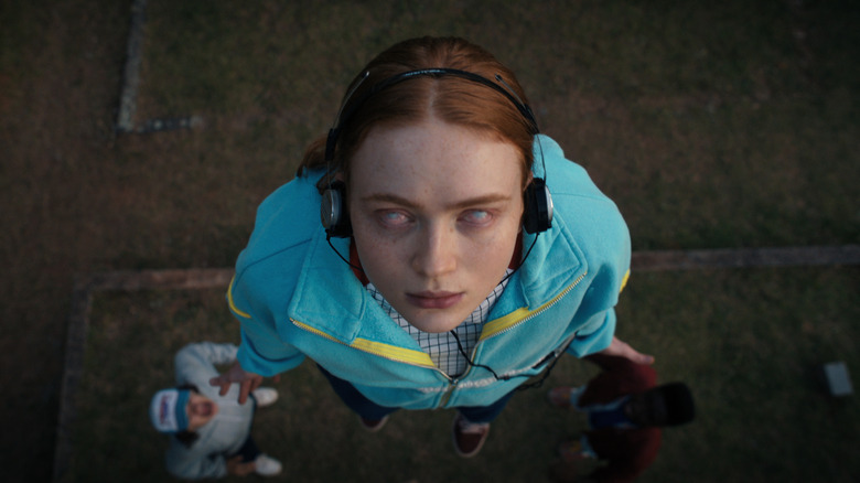 Sadie Sink as Max with her eyes rolled back floating up from the ground in Stranger Things